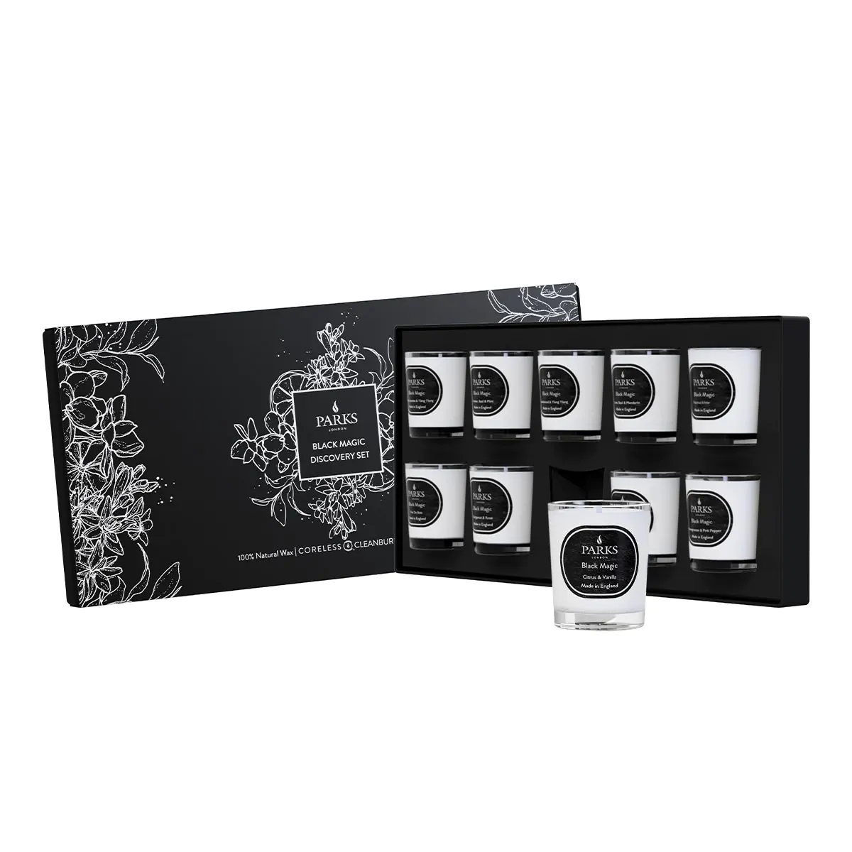 A set of ten black glass candle holders with white candles inside, arranged in a black box with a floral pattern and the brand name 'Black Magic' visible.