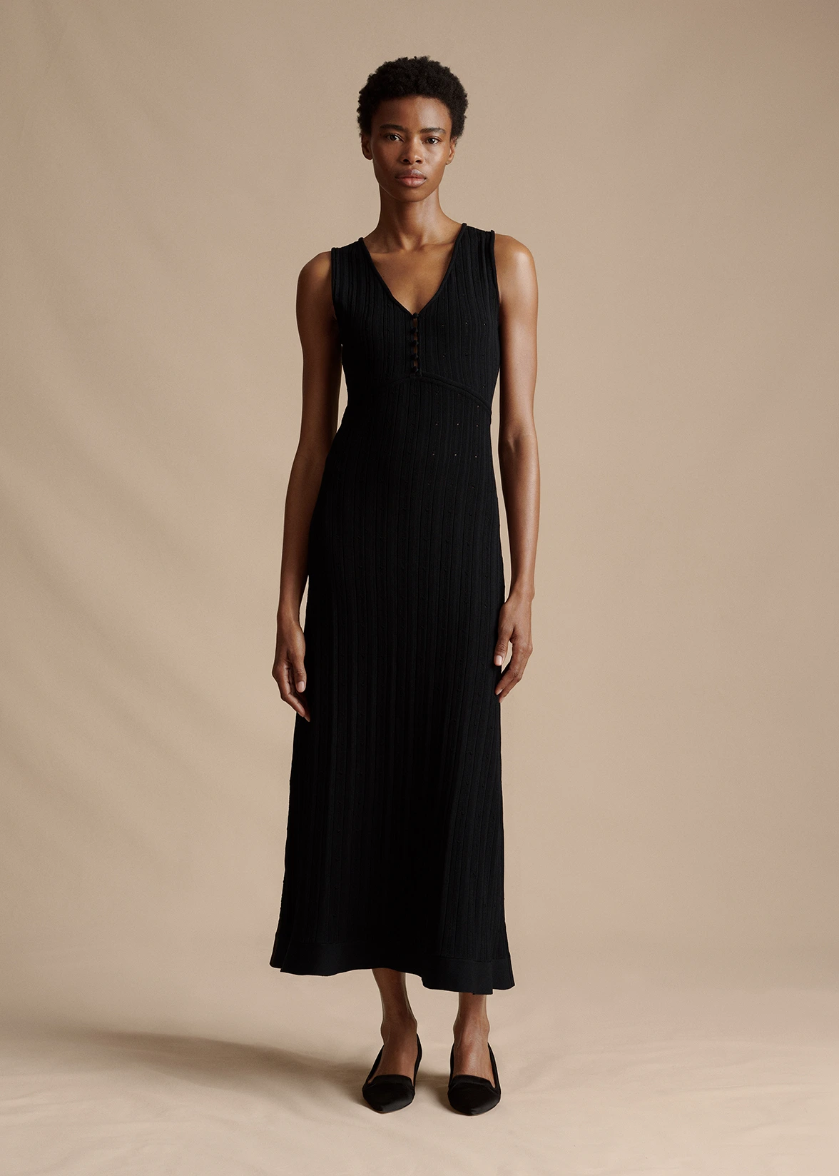 A model wearing the Mysa Dress in Ladder Knit in Black.