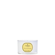 A clear glass travel candle with a label reading 'PARKS Tuberose & Ylang Ylang', indicating the fragrance of the candle.