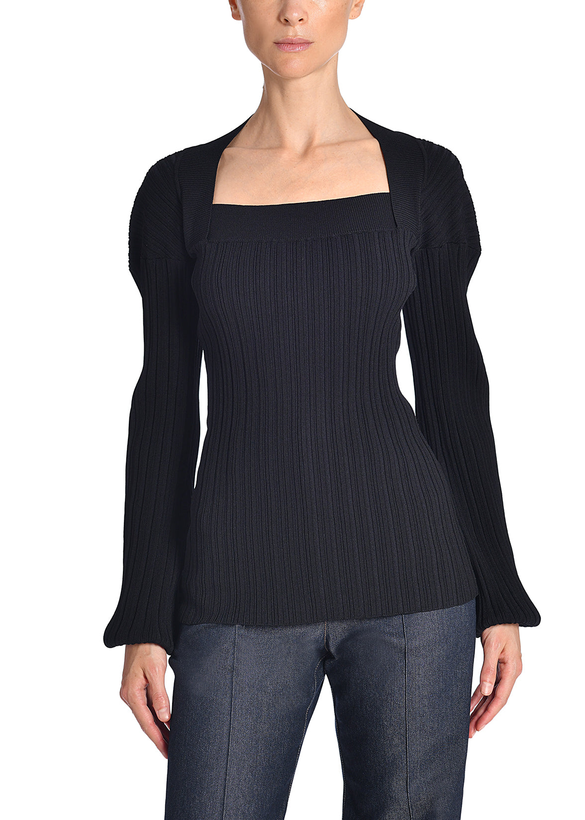 A front-facing image of a model wearing a black knit shirt 