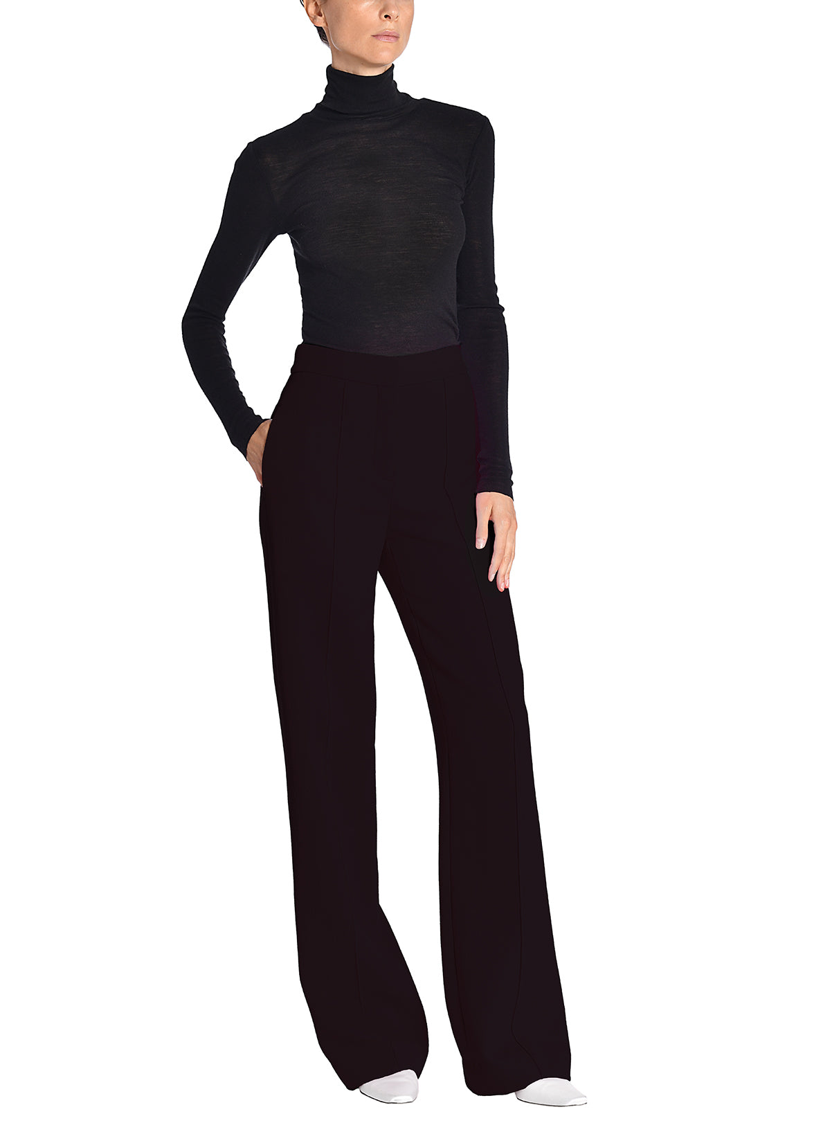 A side-facing image of amodel wearing a black turtleneck and black pants.