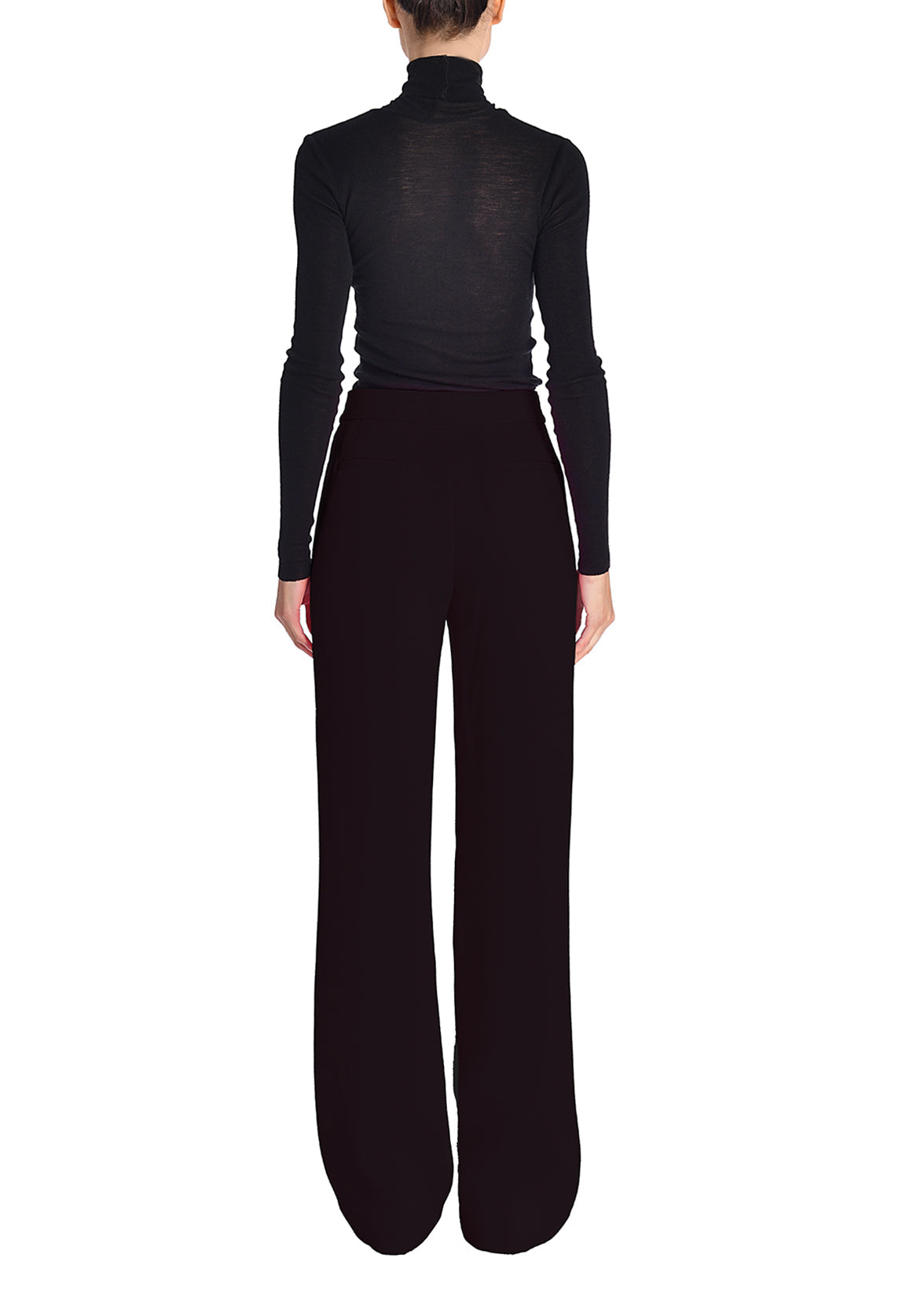 A back-facing image of a model wearing a black turtleneck and black pants.