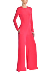 A model wearing a pink jumpsuit.