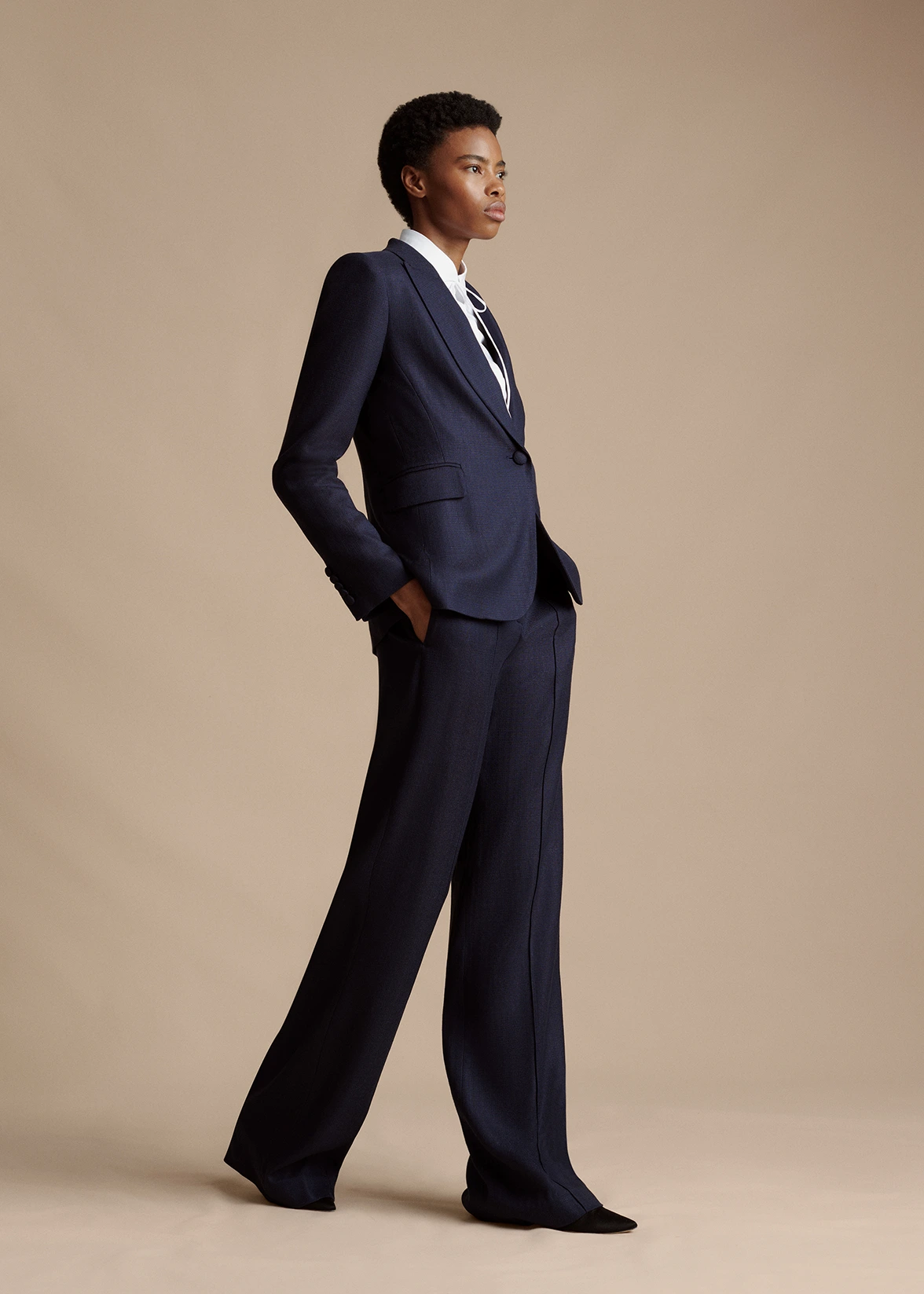 A model wearing the Full Leg Trouser in Stretch Canvas, paired with Single Breasted Blazer in Stretch Canvas.