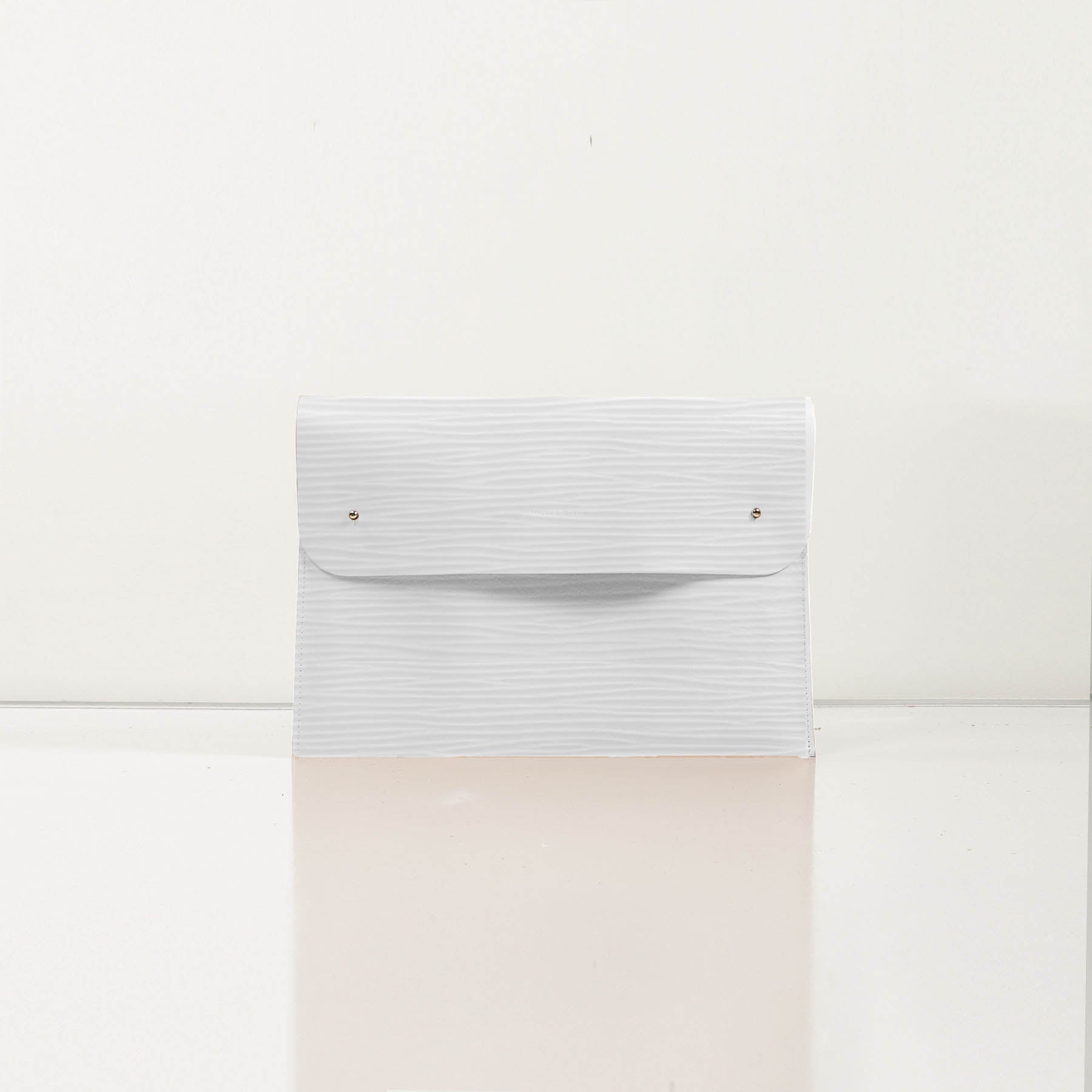 LaptopCase-WhiteWavy-Front-1-LeatherPouch-Cocoa-Debossing-WickerWings-SustainableLeatherProducts-UpcycledLeather-SmallLeatherGoods-MadeinEngland-LeatherAccessories-WickerBag-WickerHan.jpg