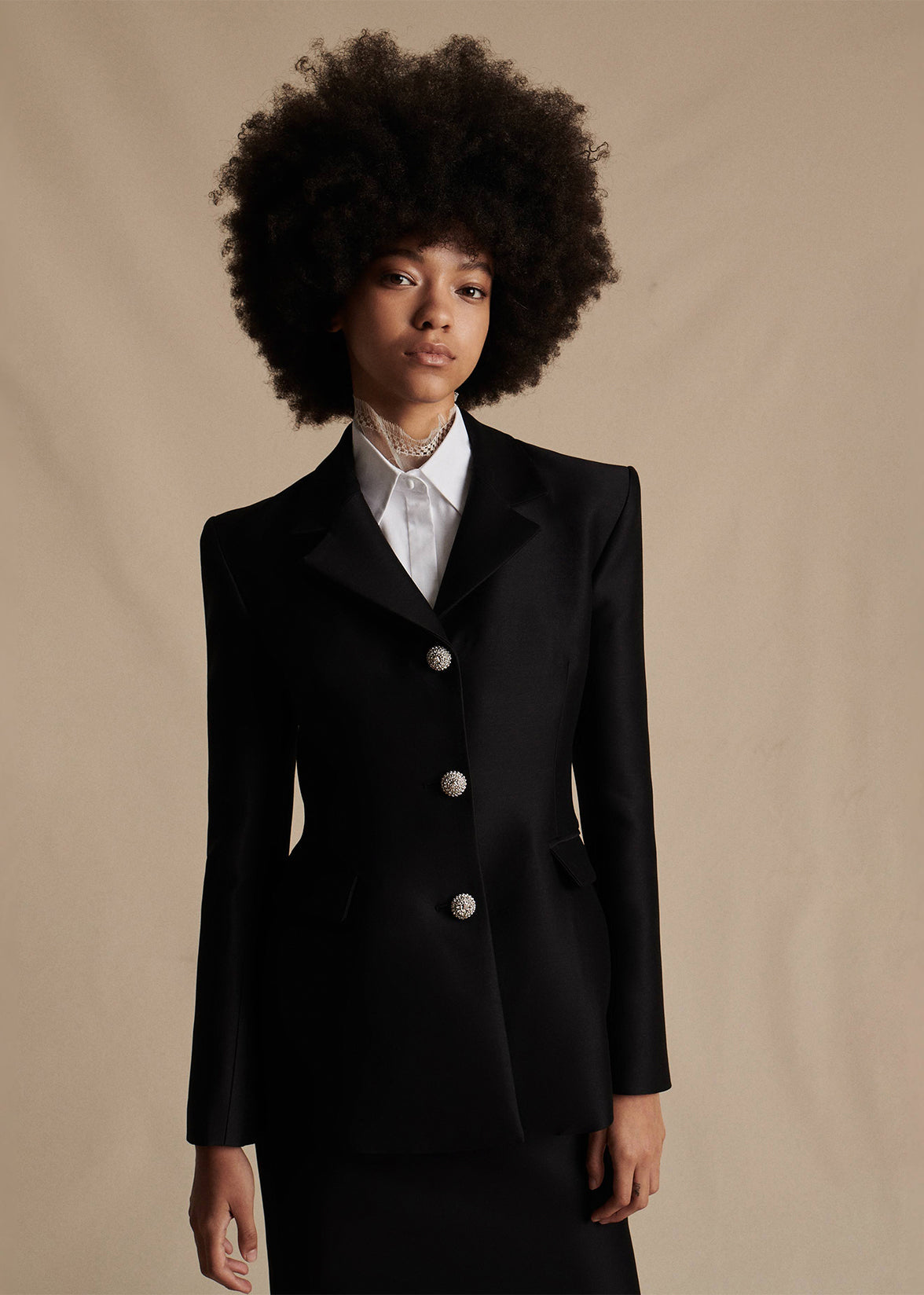 Model is wearing the white Chantilly Lace Turtleneck underneath the black Comptoir Jacket in Radzimir Wool with the matching black pencil skirt.