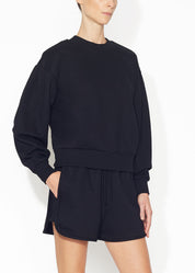 An angled view of a black sweatshirt.