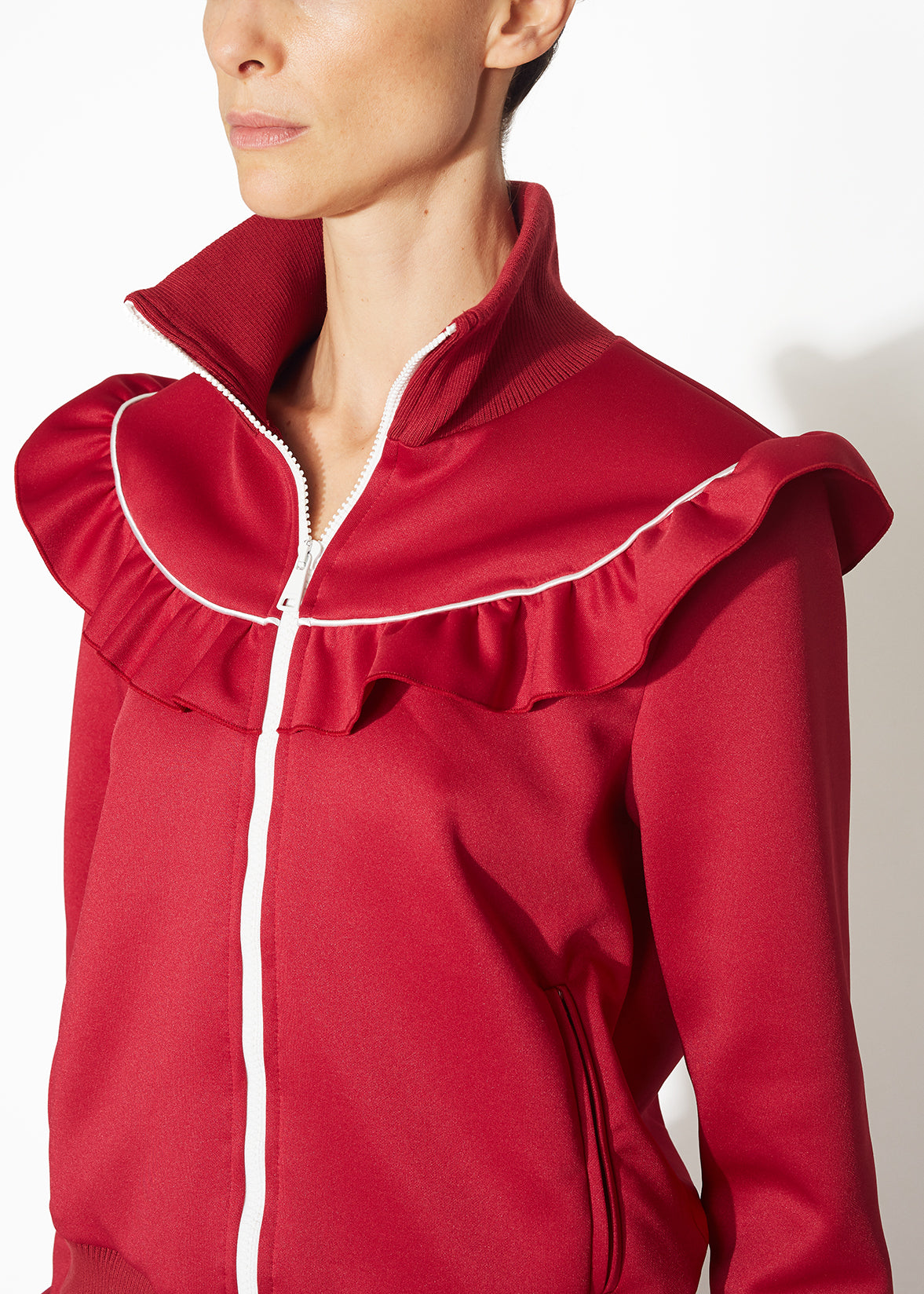 A detailed view of a burgundy track jacket.