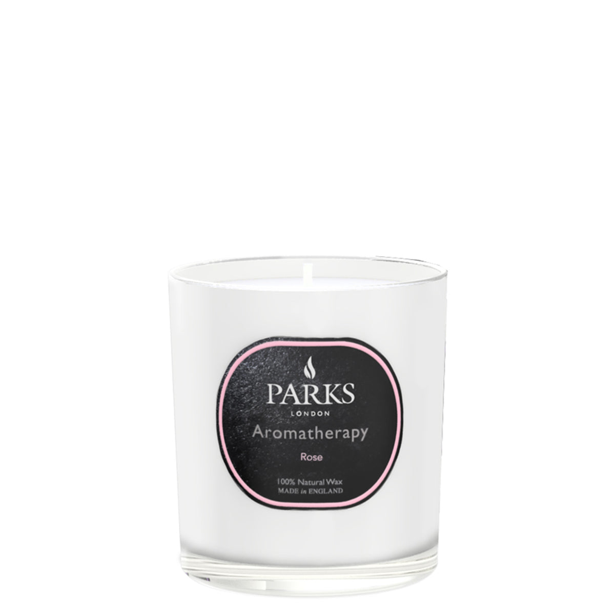 A white aromatherapy candle with the label 'PARKS' in the center, surrounded by pink roses and green foliage.