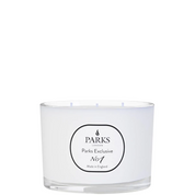 A white, three-wick candle with the label 'PARKS Exclusive No1'.