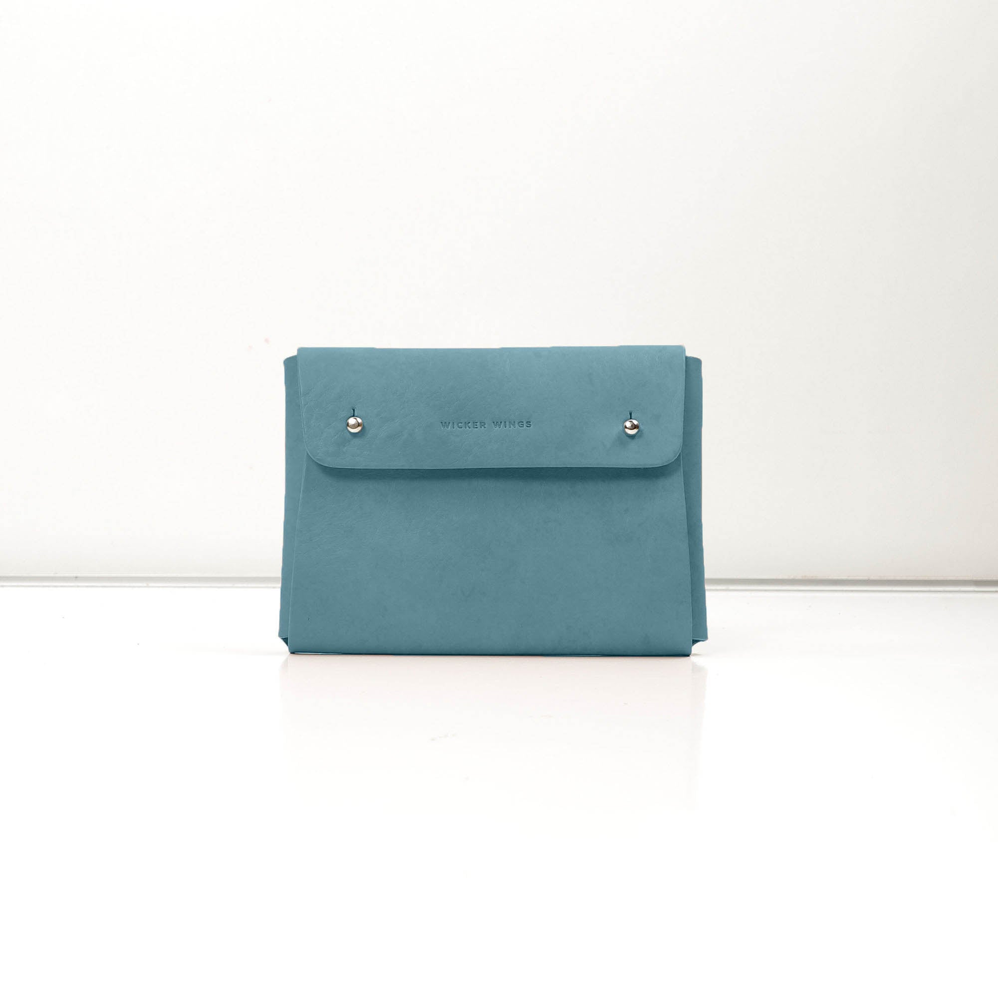 Pouch-Kuai-Teal-Medium-Front-1-Leather_Pouch-Cocoa-Debossing-Wicker_Wings-Sustainable_Leather_Products-Upcycled_Leather-Small_Leather_Goods-Made_in_England-Leather_Accessories-Wicker.jpg