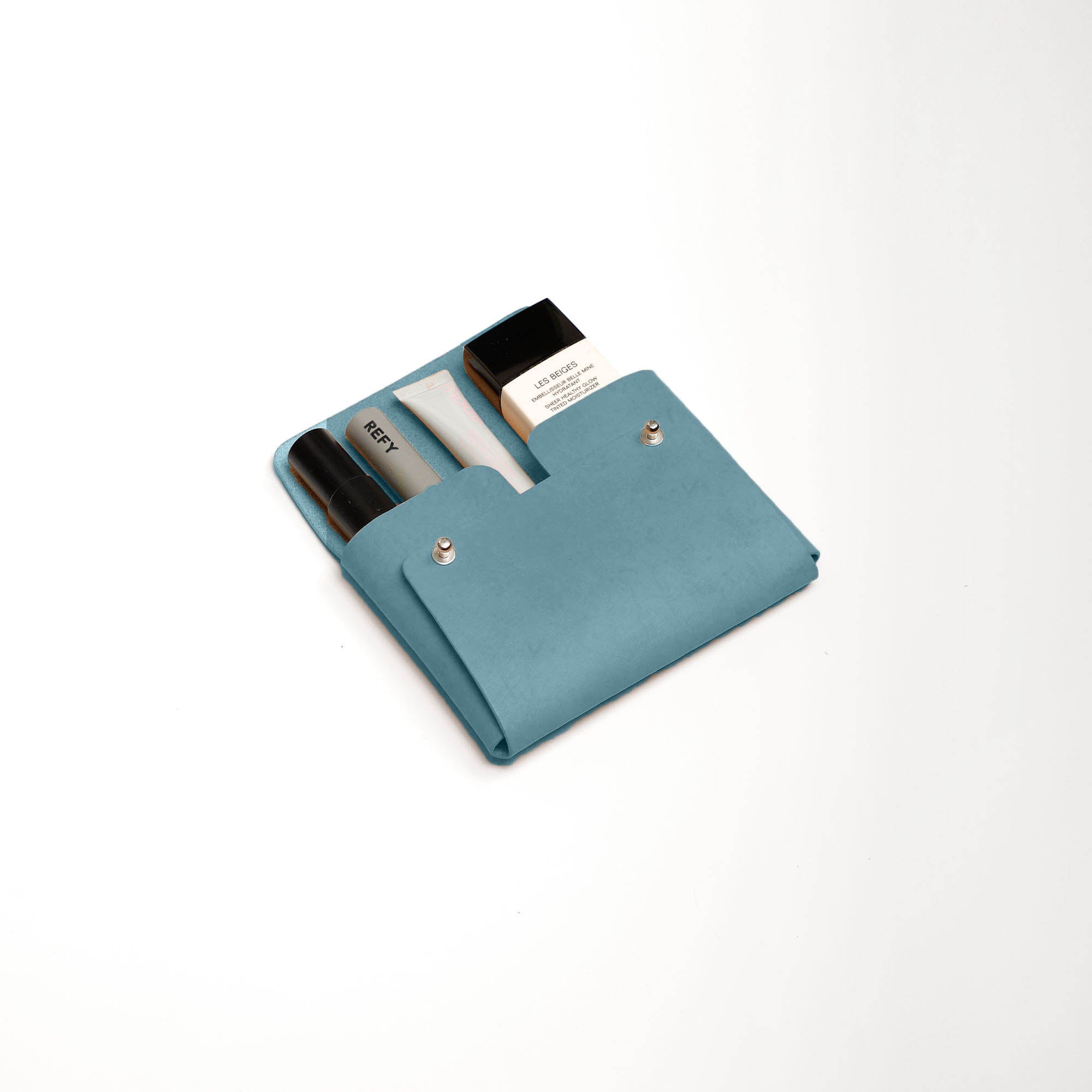 Pouch-Kuai-Teal-Medium-Front-3-Leather_Pouch-Cocoa-Debossing-Wicker_Wings-Sustainable_Leather_Products-Upcycled_Leather-Small_Leather_Goods-Made_in_England-Leather_Accessories-Wicker.jpg