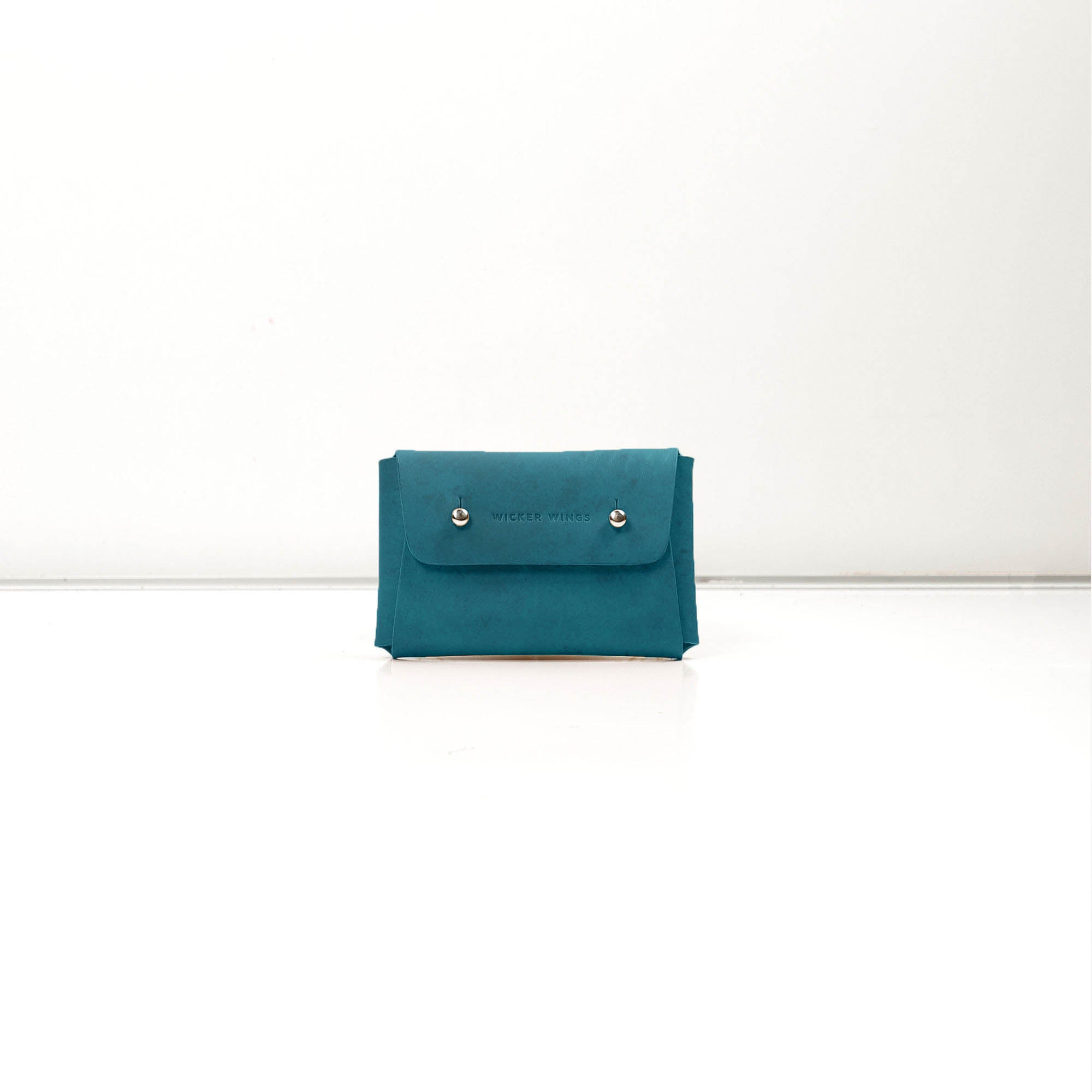 Pouch-Kuai-Teal-Small-Front-1-LeatherPouch-Cocoa-Debossing-WickerWings-SustainableLeatherProducts-UpcycledLeather-SmallLeatherGoods-MadeinEngland-LeatherAccessories-WickerBag-WickerHa_1c00df97-7198-4213-a5ee-293960833312.jpg