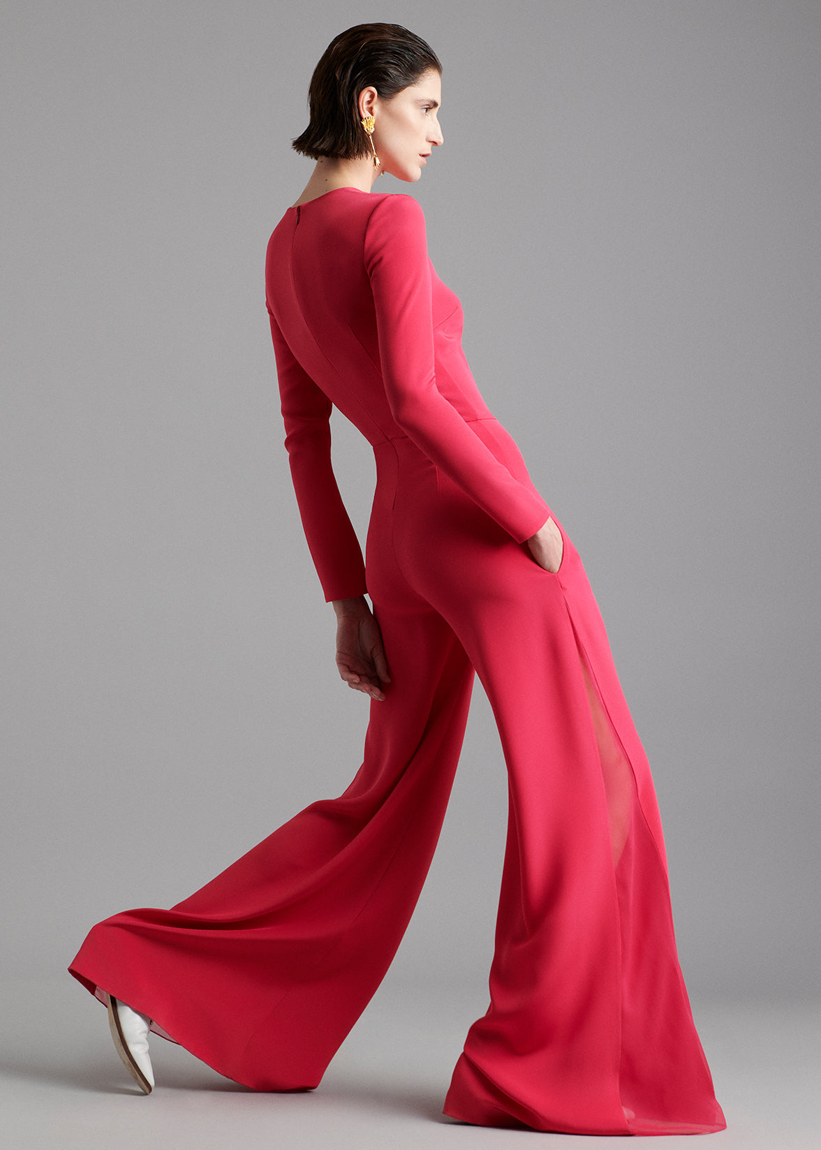 A model wearing a raspberry jumpsuit.