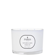 A white, three-wick candle with a label that reads 'PARKS NATURE'S OWN NORDIC SPA'.