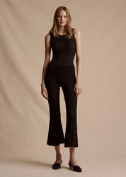 Model is wearing the Cropped Pant in Black Pointelle Knit with the matching Black Shell Top.