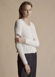 Model is wearing the ivory Cardigan with peplum in pointelle knit with the Denim Deeda Pant.