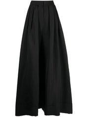 A flat lay of a pair of black pleated wide leg pants.