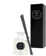 A grapefruit & tangerine scented diffuser with black sticks and a white bottle, next to its black box packaging with 'Black Magic' and product details.