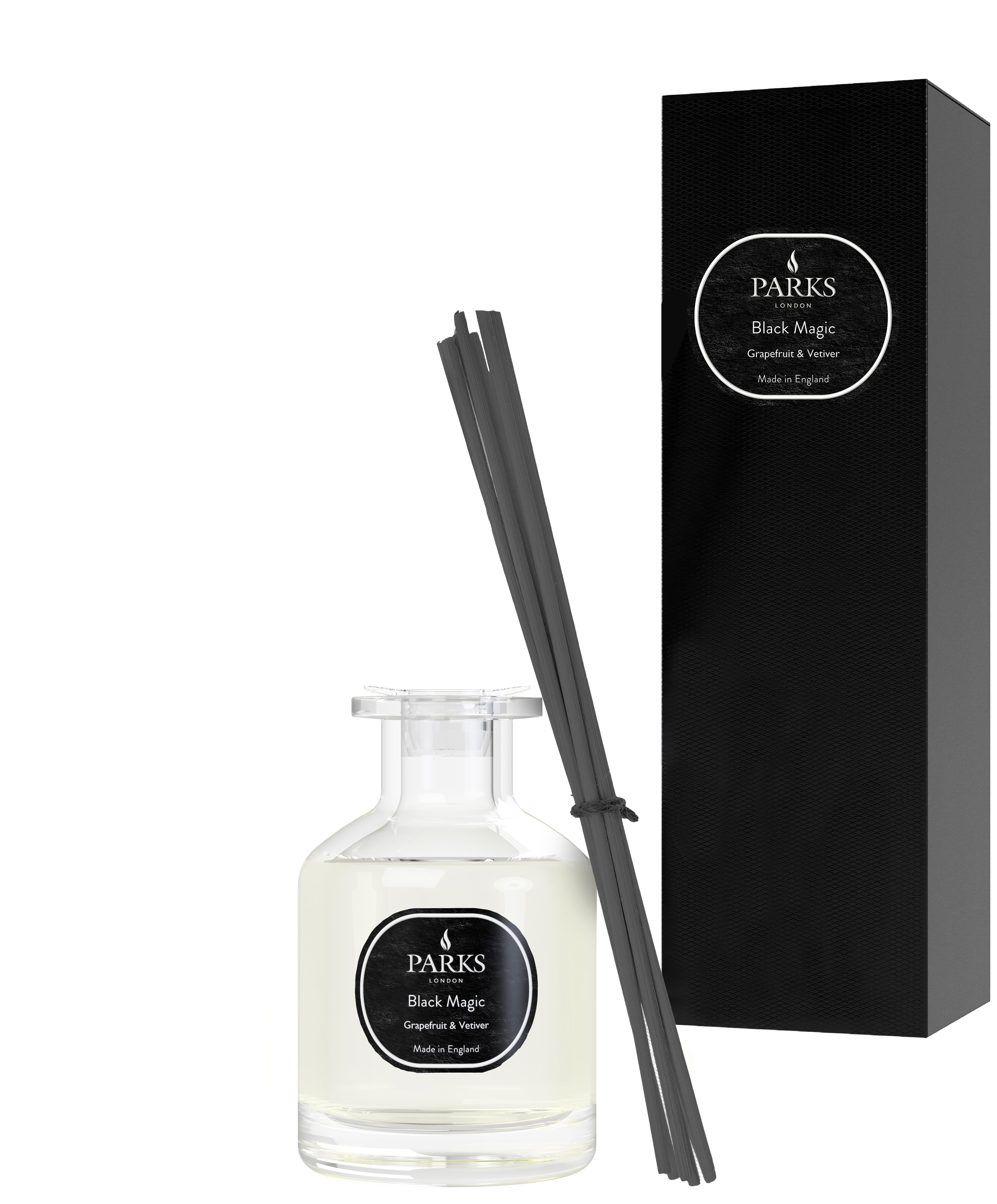 A grapefruit & tangerine scented diffuser with black sticks and a white bottle, next to its black box packaging with 'Black Magic' and product details.