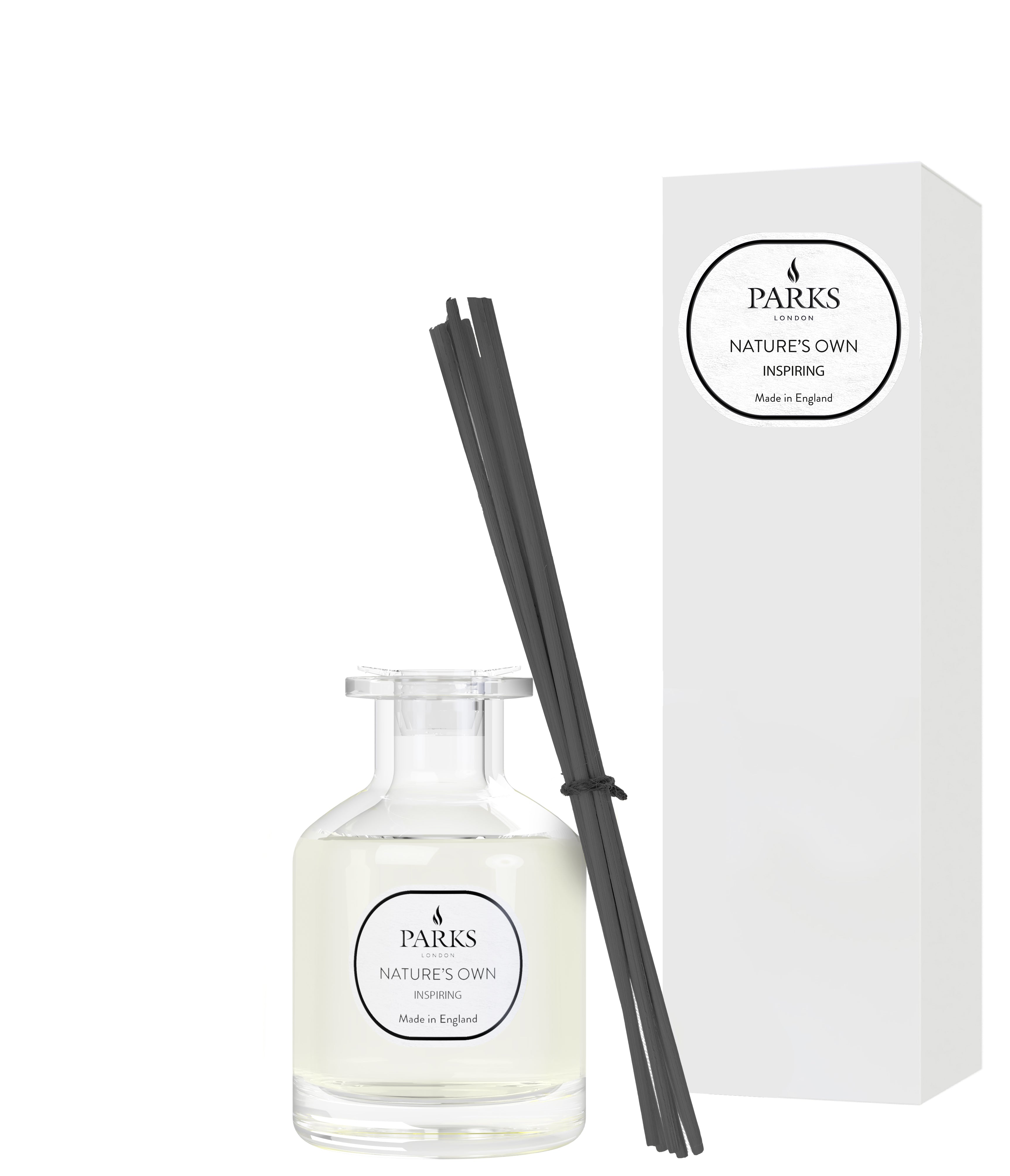 A white reed diffuser with a label reading 'PARIS' next to a white box with the word 'INSPIRING' on it, containing a clear glass bottle with a white liquid and several black reeds.