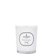 A white candle with a label reading 'PARKS Exclusive No6' in a clear glass vessel.