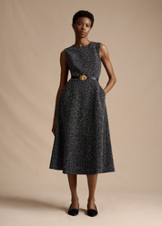 Model posing and wearing the Eloise Dress in Corded Tweed with the Double Knot Belt.